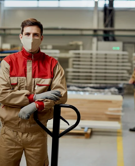 c278c80d-8c3e-4402-823c-09d15c8c11a3-manual-worker-with-face-mask-working-carpentry-warehouse-coronavirus-pandemic.jpg